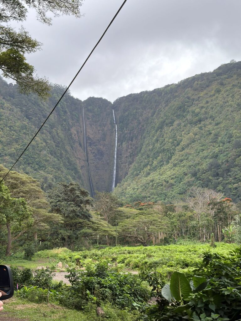 waipio valley cascading waterfall into valley